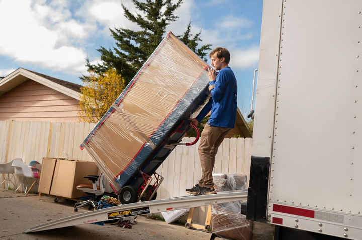 man moving large box onto truck hercules moving